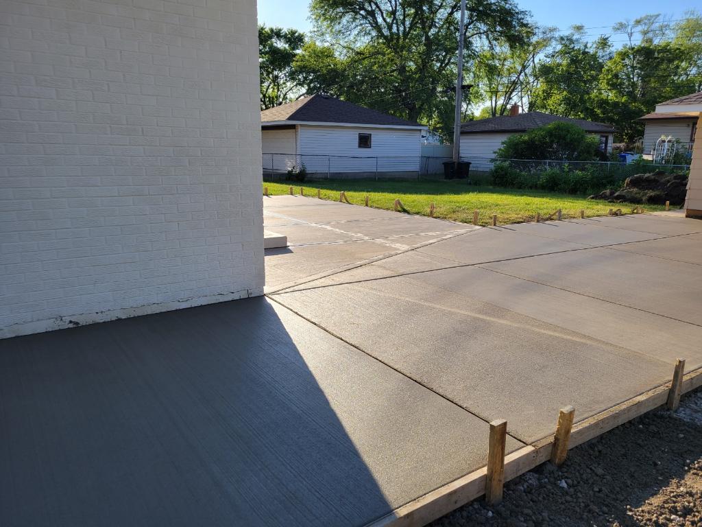 Finished concrete driveway beside a house