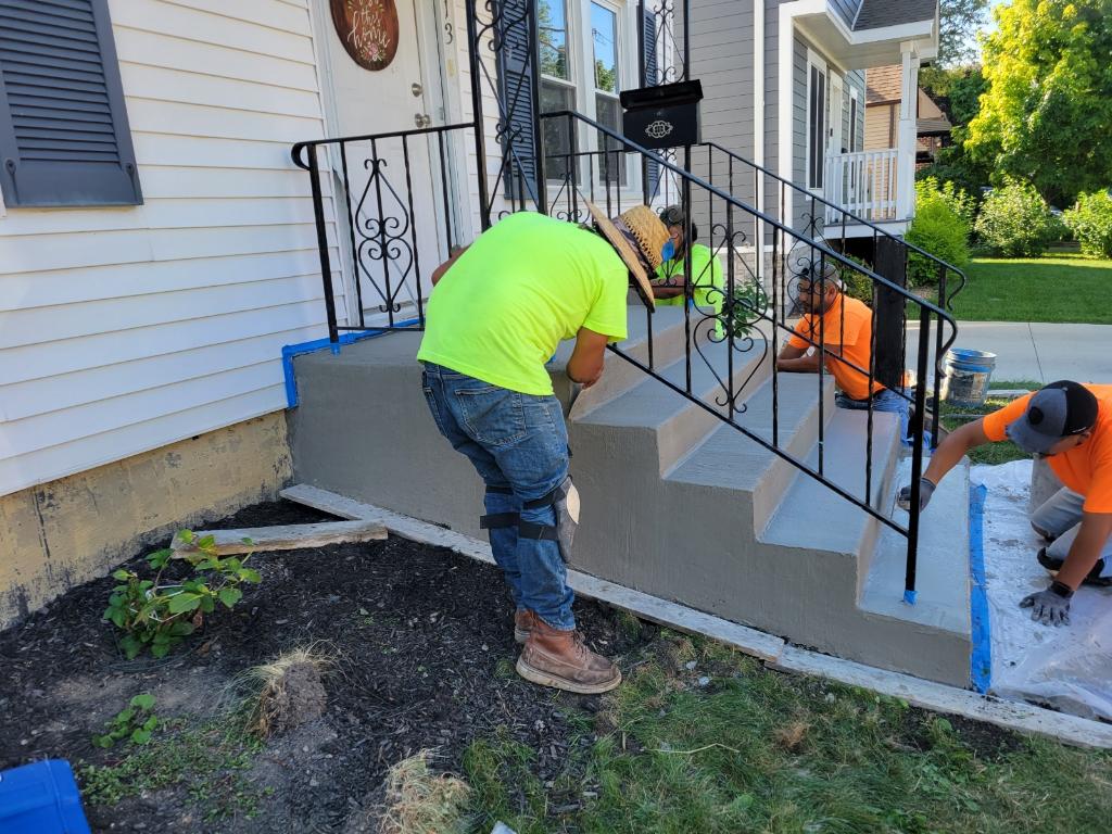 Crew finishing concrete steps and walkway