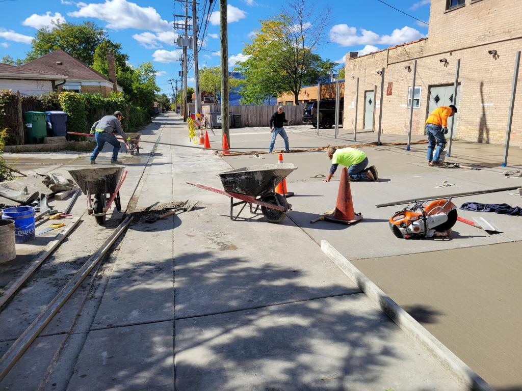 Concrete crew finishing a driveway